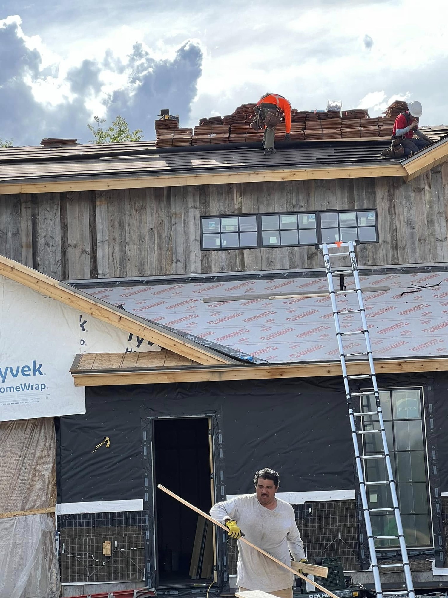 Crew on roof and siding